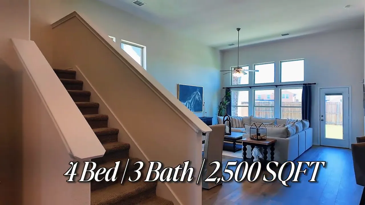 Wide view of living room with large windows and seating in a 4 bed 3 bath 2,500 square foot new construction home