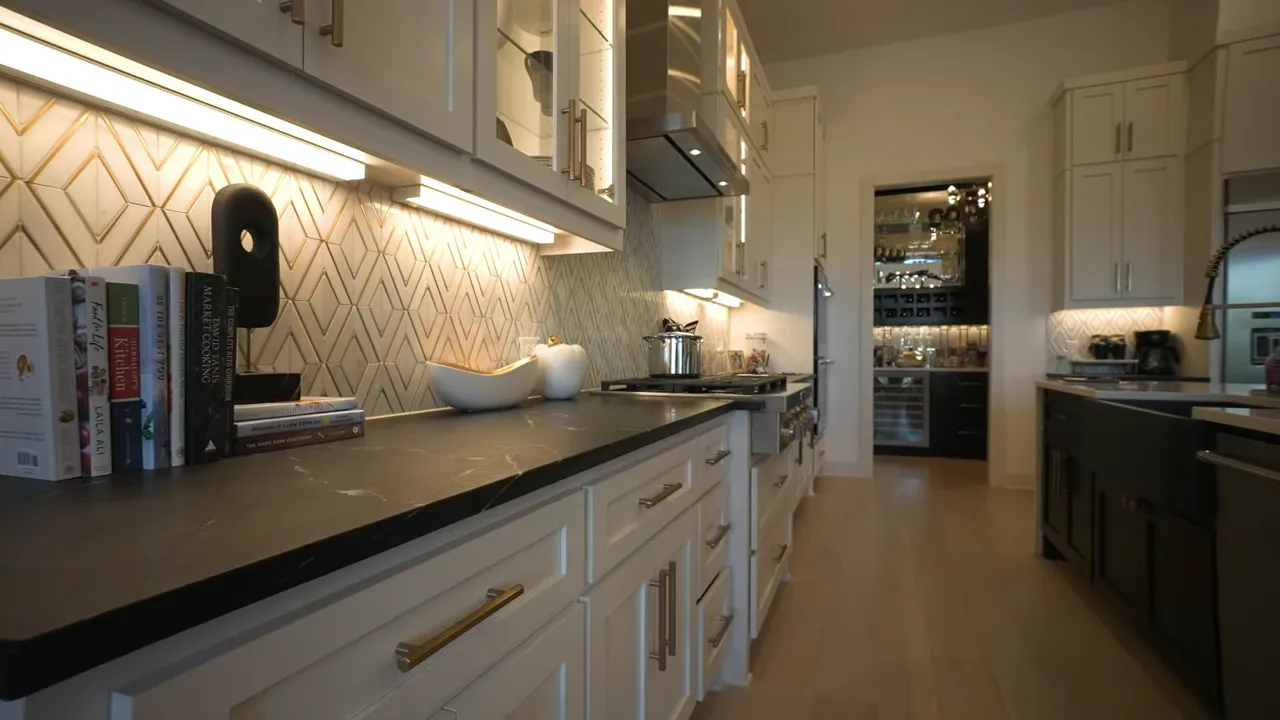 Butlers pantry with dark cabinets wine cooler shelves and counter space