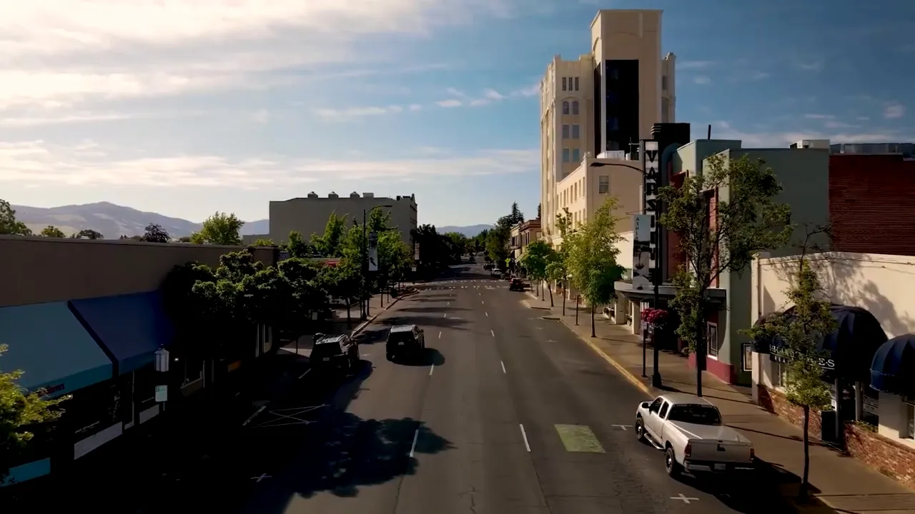 Google Earth overhead map labeled 'DOWNTOWN PLAZA' showing the Plaza, Oregon Shakespeare Festival and surrounding streets.