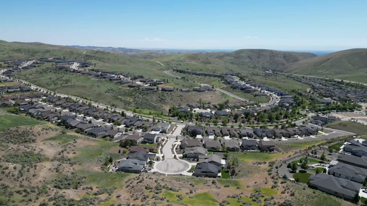 Presenter on a balcony overlooking a park, green space, and neighborhood trails in a Boise master-planned community