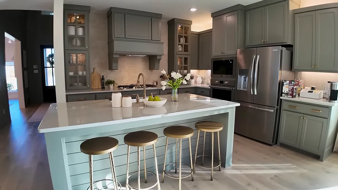 Light-colored hardwood floors leading into kitchen