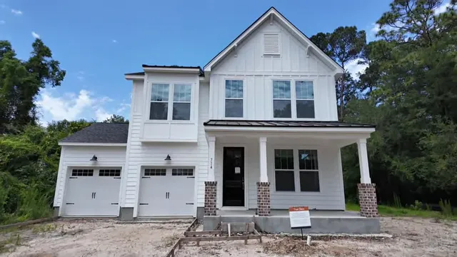 White two story home on a large wooded historic lot