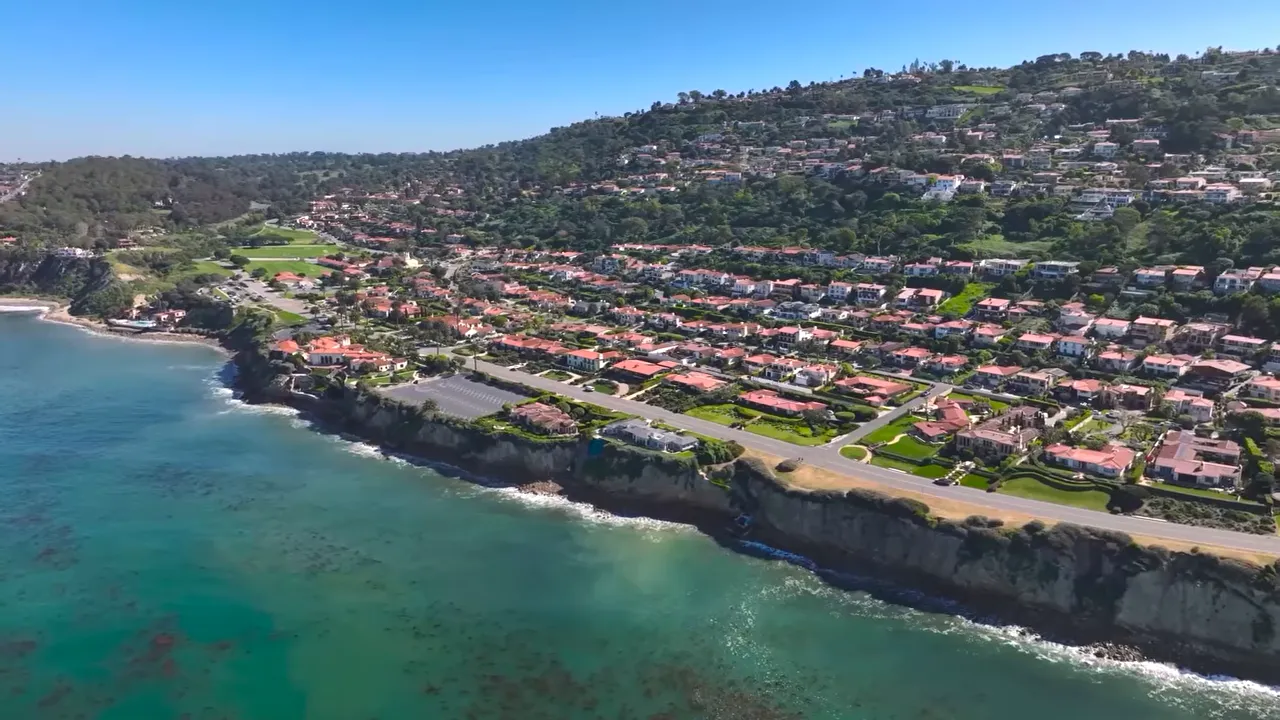 Aerial view of canal-side homes near Los Angeles showing the waterway between properties
