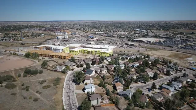 Slide listing key points covered in the video over an aerial neighborhood view