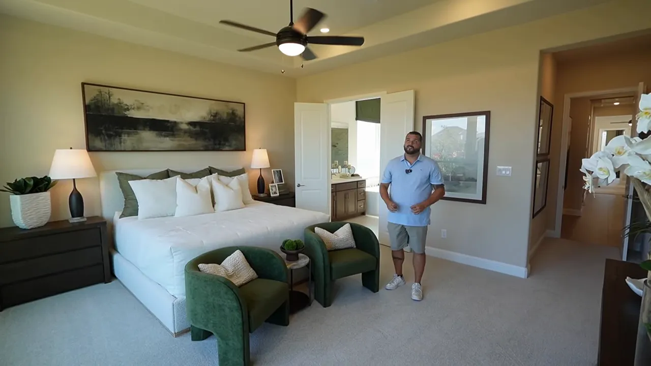 Primary bedroom with tray ceiling and three large rear windows
