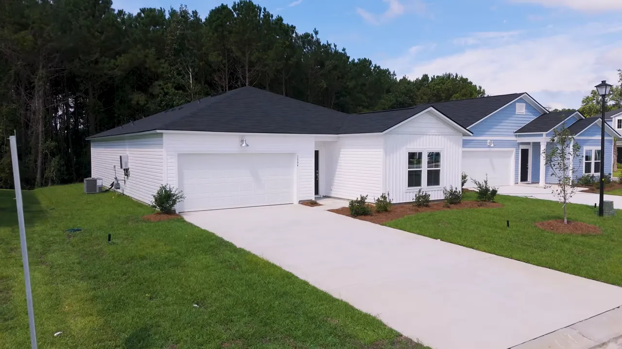 Secondary bedroom with large windows and natural light in a new construction home in Little River SC