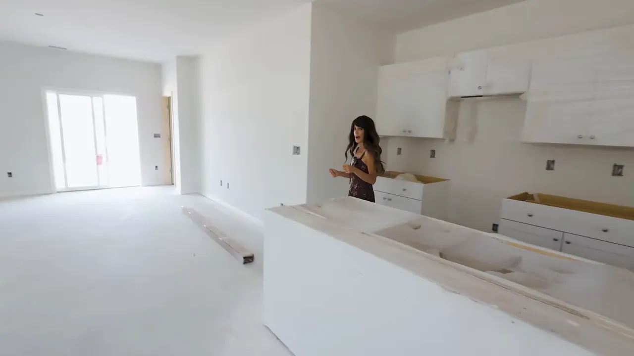 Downstairs primary bedroom area in a new construction two-story home in Little River, SC with unfinished walls and dark flooring