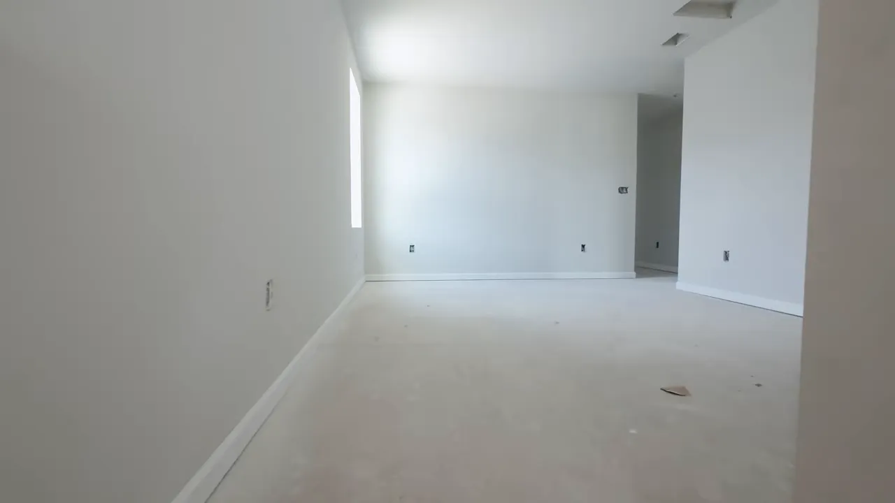 Empty upstairs loft area in a new construction Little River SC home with large window light
