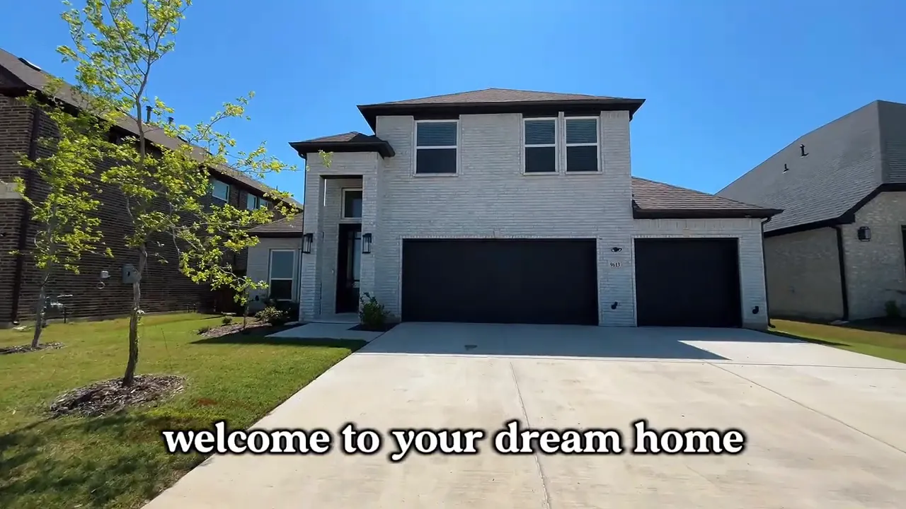 Modern white brick two story home with black garage doors and wide driveway