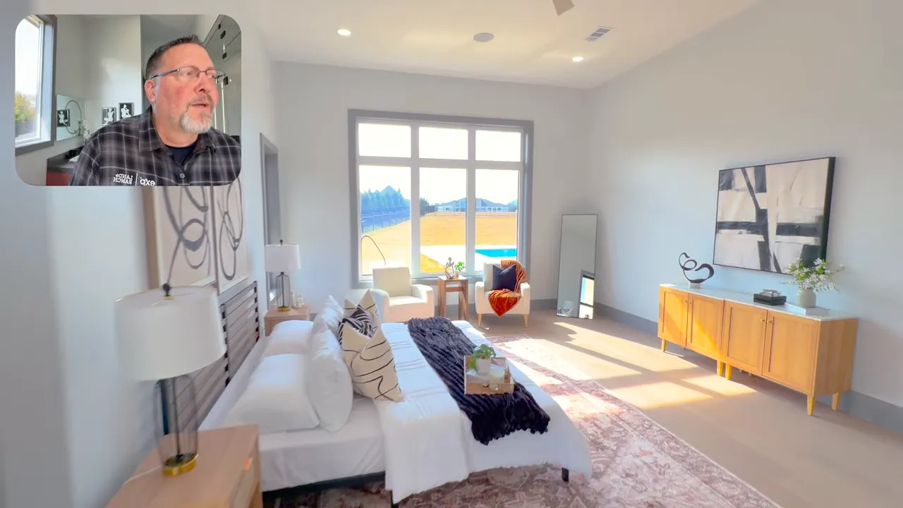 Primary walk-in closet with glass-top island, LED-lit shelving and built-in drawers.