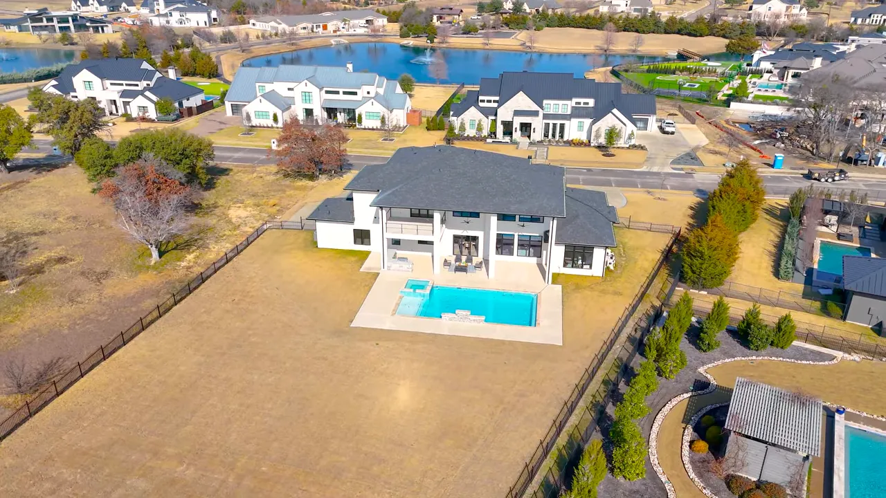 rear elevation of house with covered patio, balcony and pool with integrated spa, small presenter inset