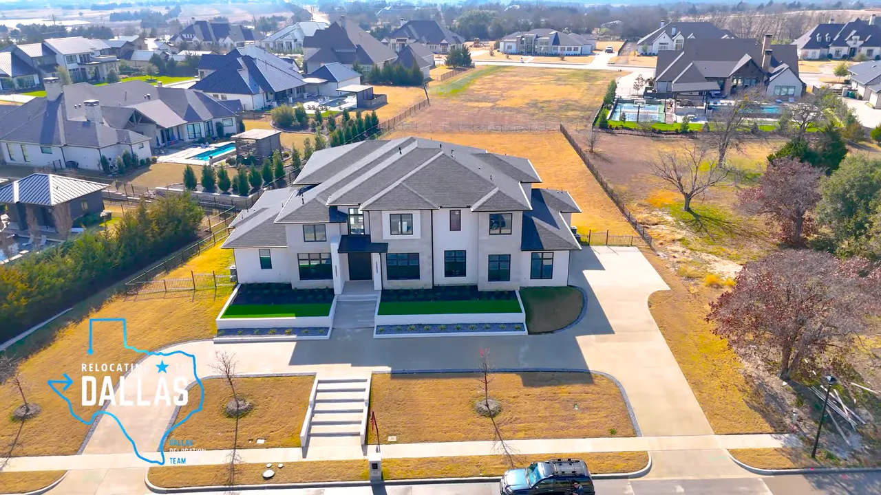 Covered front porch with large black steel entry door and transom window