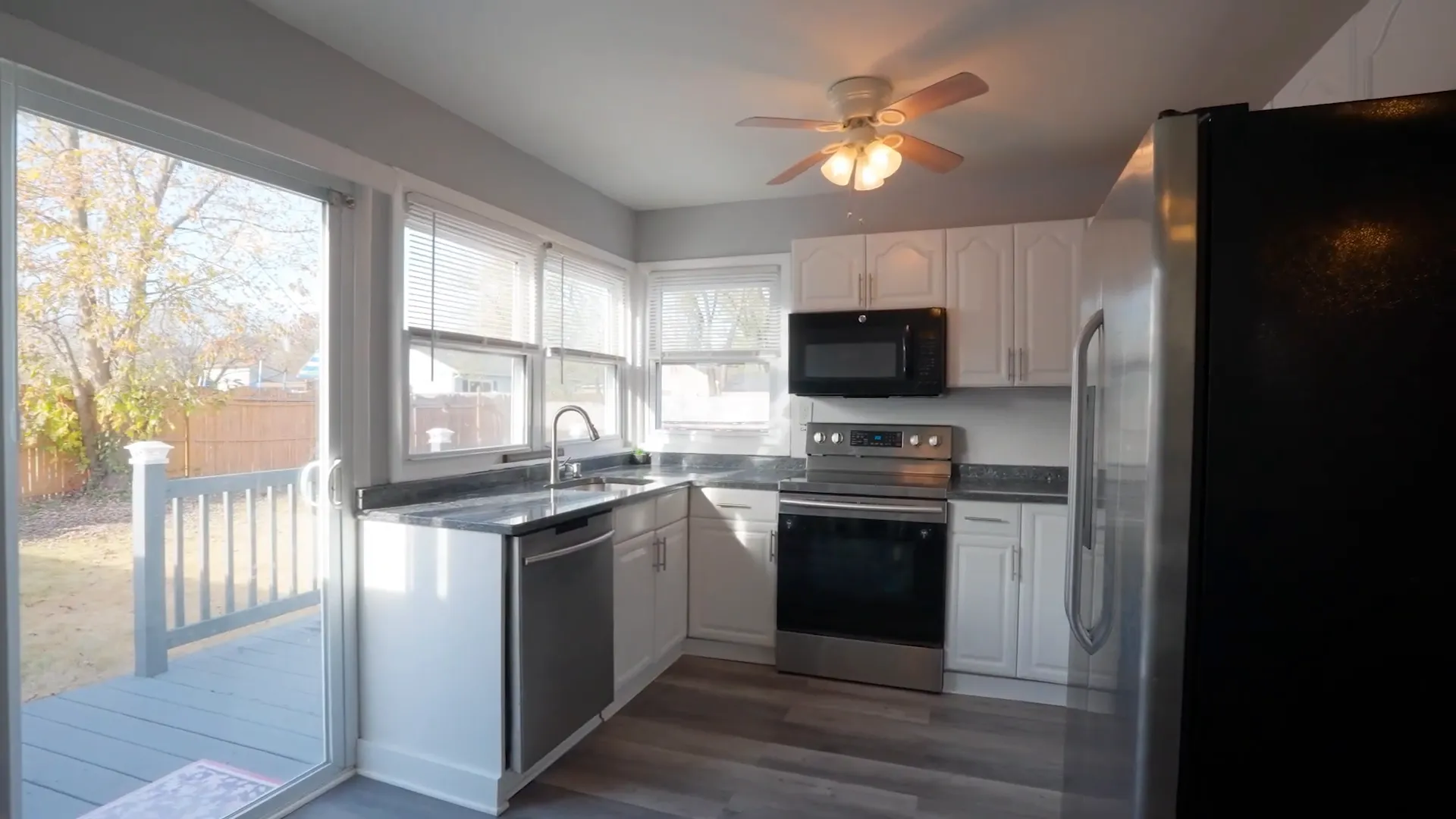 Updated kitchen with modern appliances and backyard view