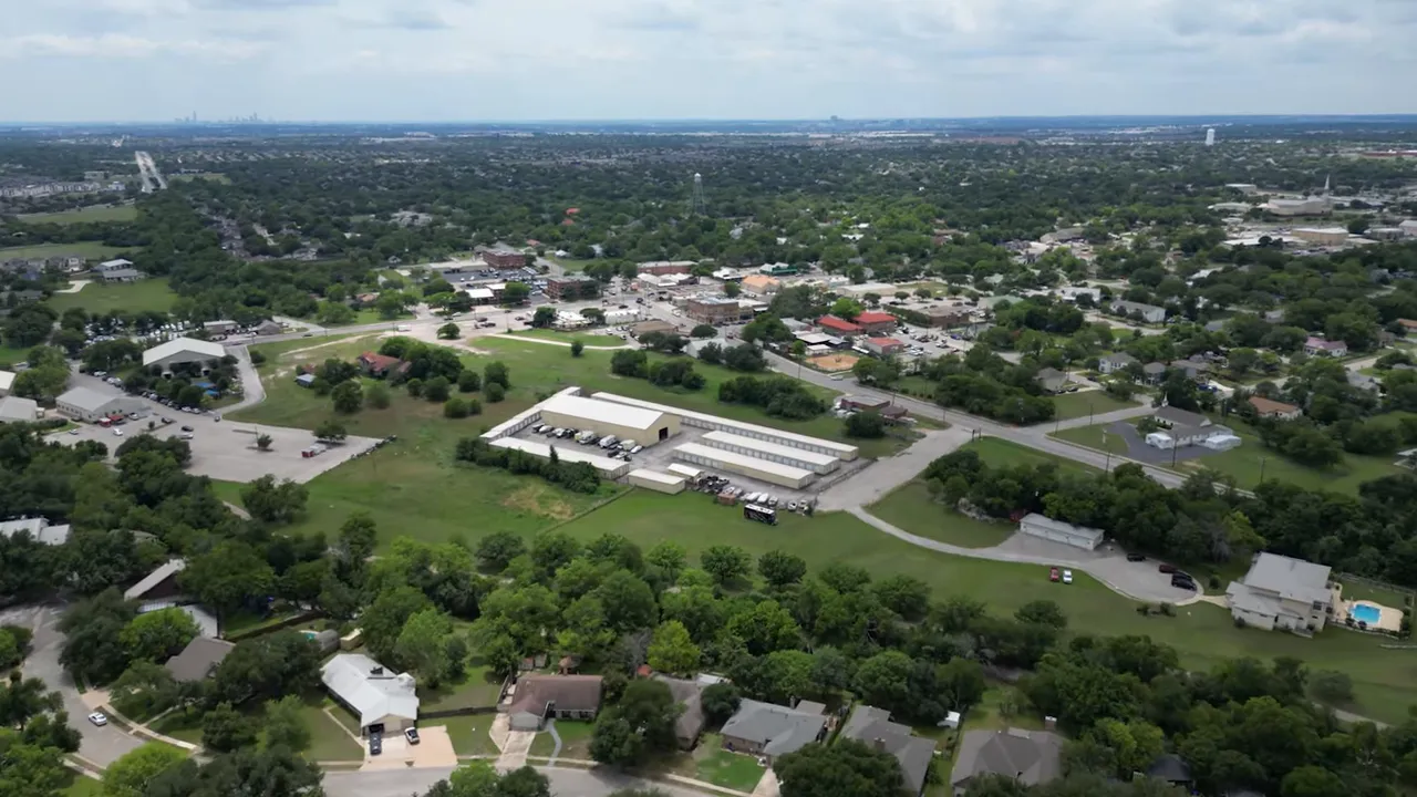 Aerial view of a community swimming pool, surrounding park, and trails in Pflugerville with overlay text for '#5'.
