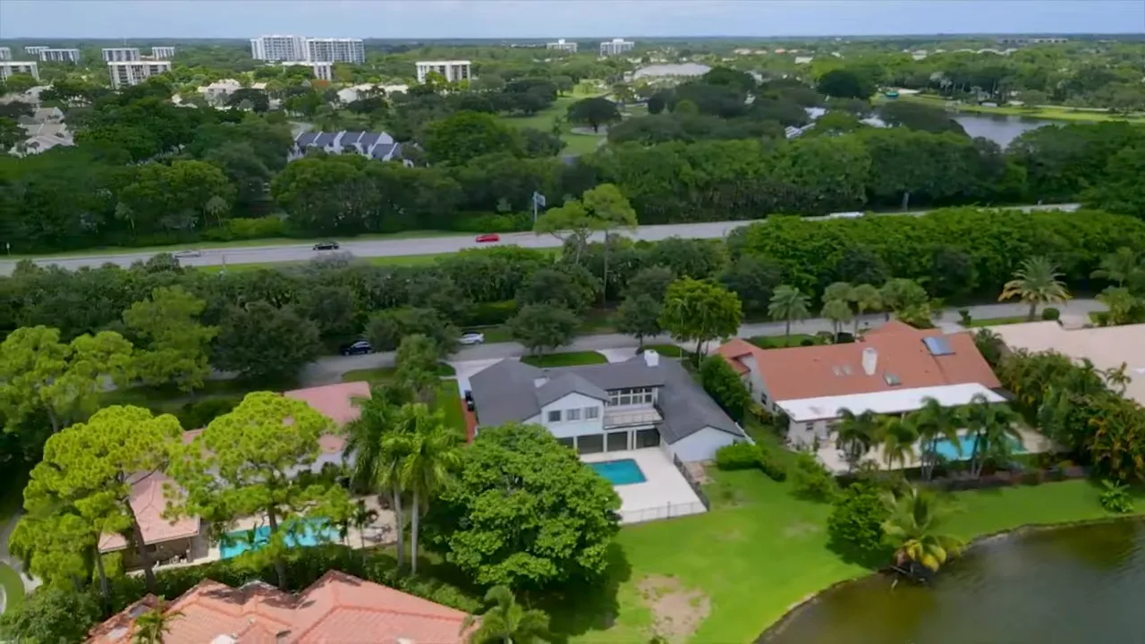 Estancia street lined with mature trees and single-story homes