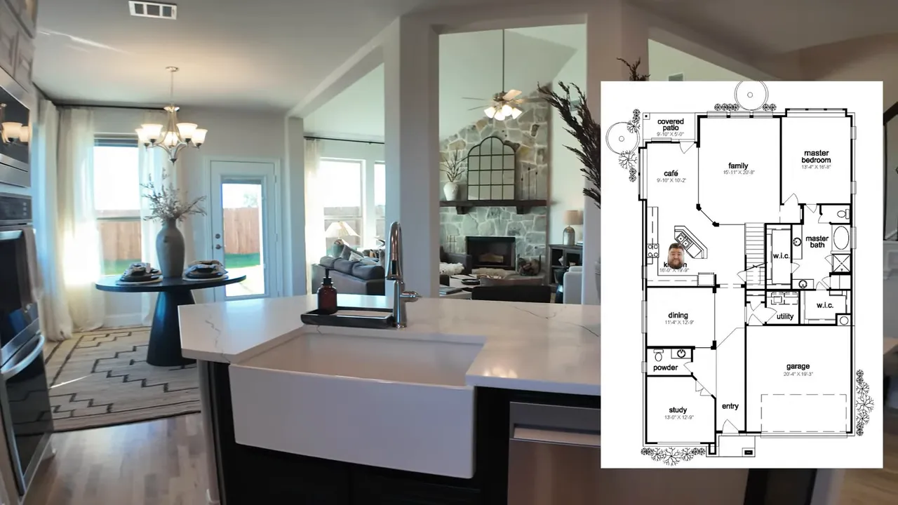 aerial view of a two-story Bellflower II model home on a wide lot showing driveway and adjacent empty lots