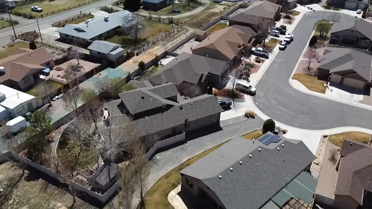 Neighborhood park and street in Grand Junction with pavilion and open lots