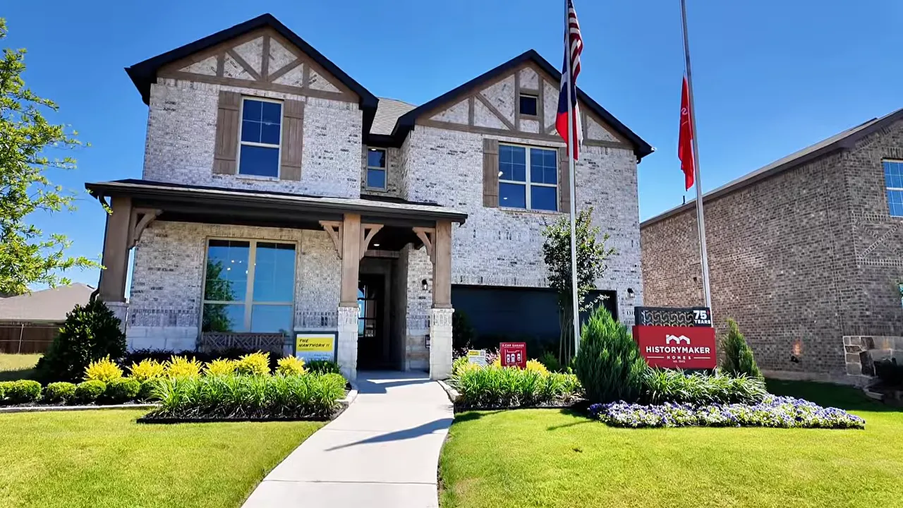 Front exterior of two story brick home with landscaped walkway