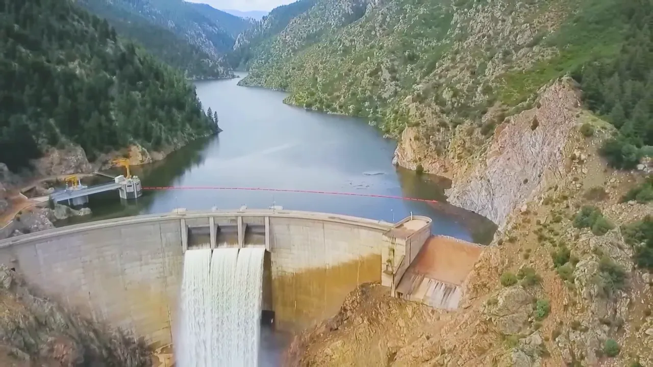 Lake or river shoreline in Denver with winter snow and open water