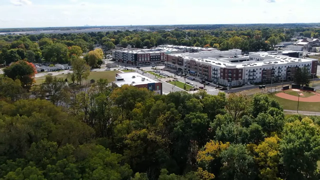 Close aerial view of warehouse with side and roof torn away from tornado damage
