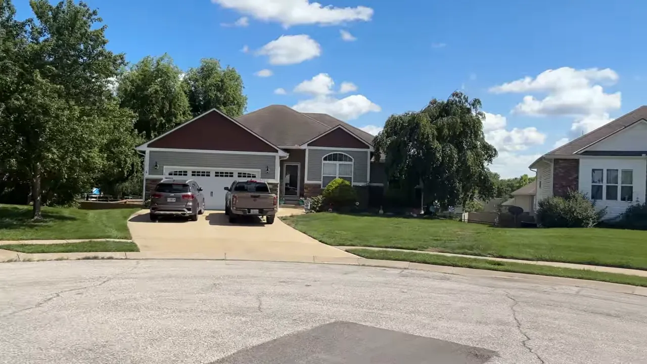 Front exterior of a single-story brick home with a wide lawn