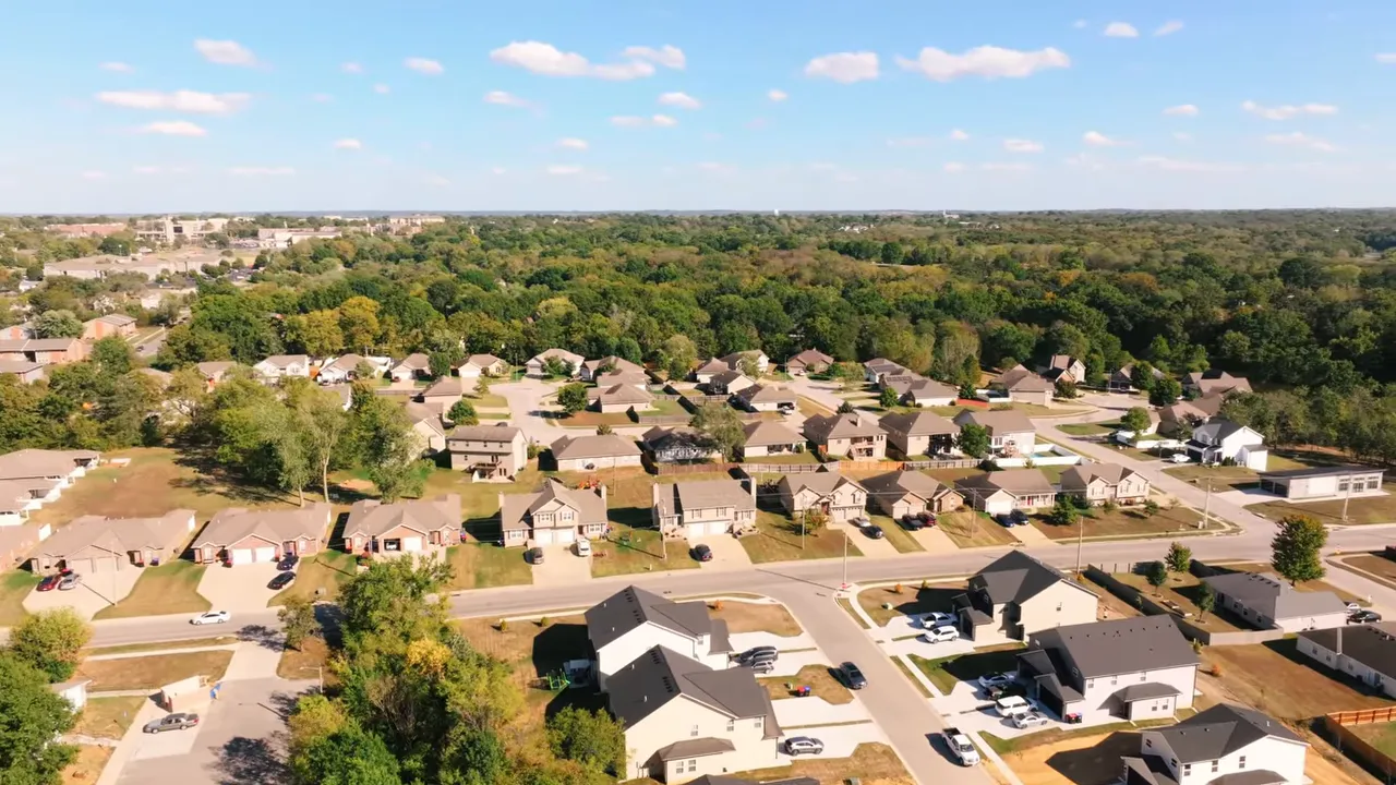 Drone view of Oakmont showing curved streets, newer homes, and surrounding trees