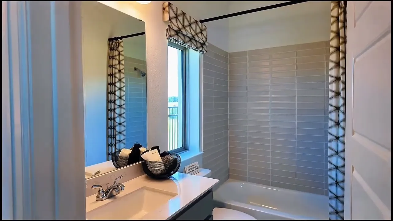 Bathroom vanity and shower area with text reading every bedroom equals en suite