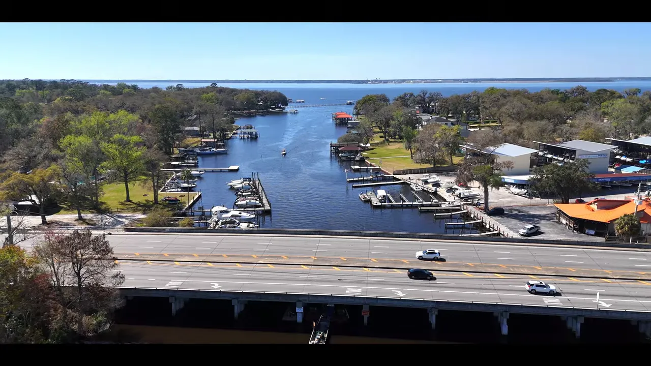 Aerial view of residential lots and new homes with large green text overlay showing 