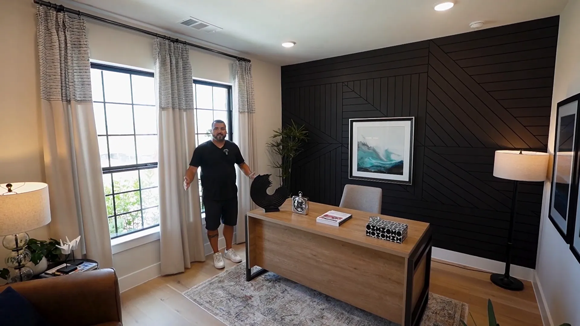 Home office with double glass French doors and wood accent wall