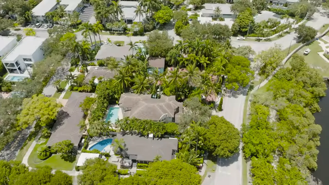 Presenter standing in a shaded park with wide oak canopy, green lawn and a 'Parking for park patrons only' sign in Victoria Park