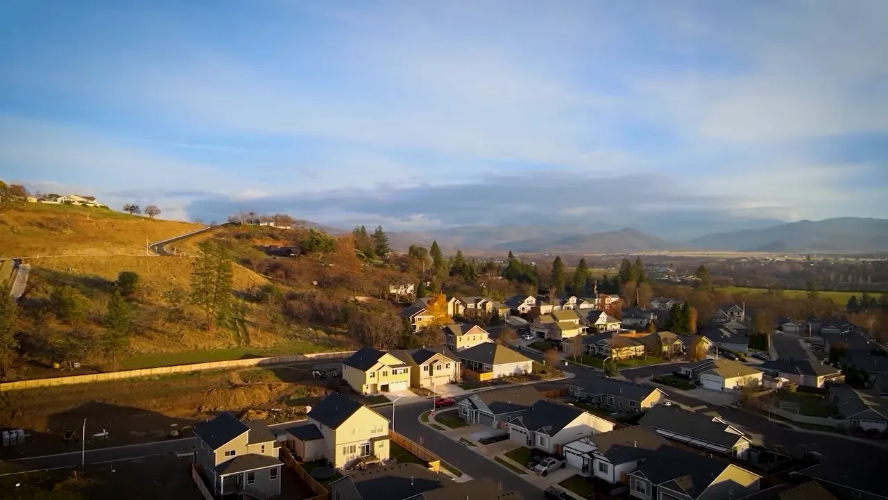 Exterior photo of a newly built home with a driveway and garage in Southern Oregon