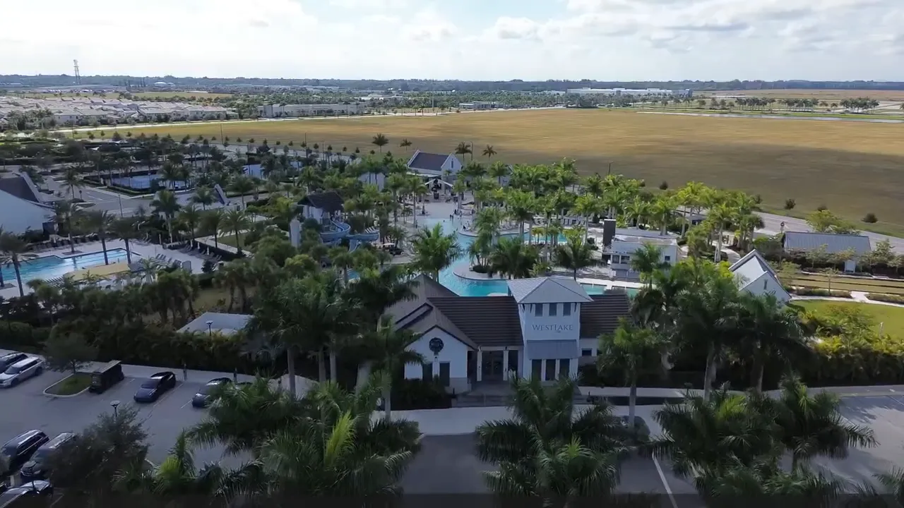 Aerial view of Westlake homes and lake with city being built with intention text