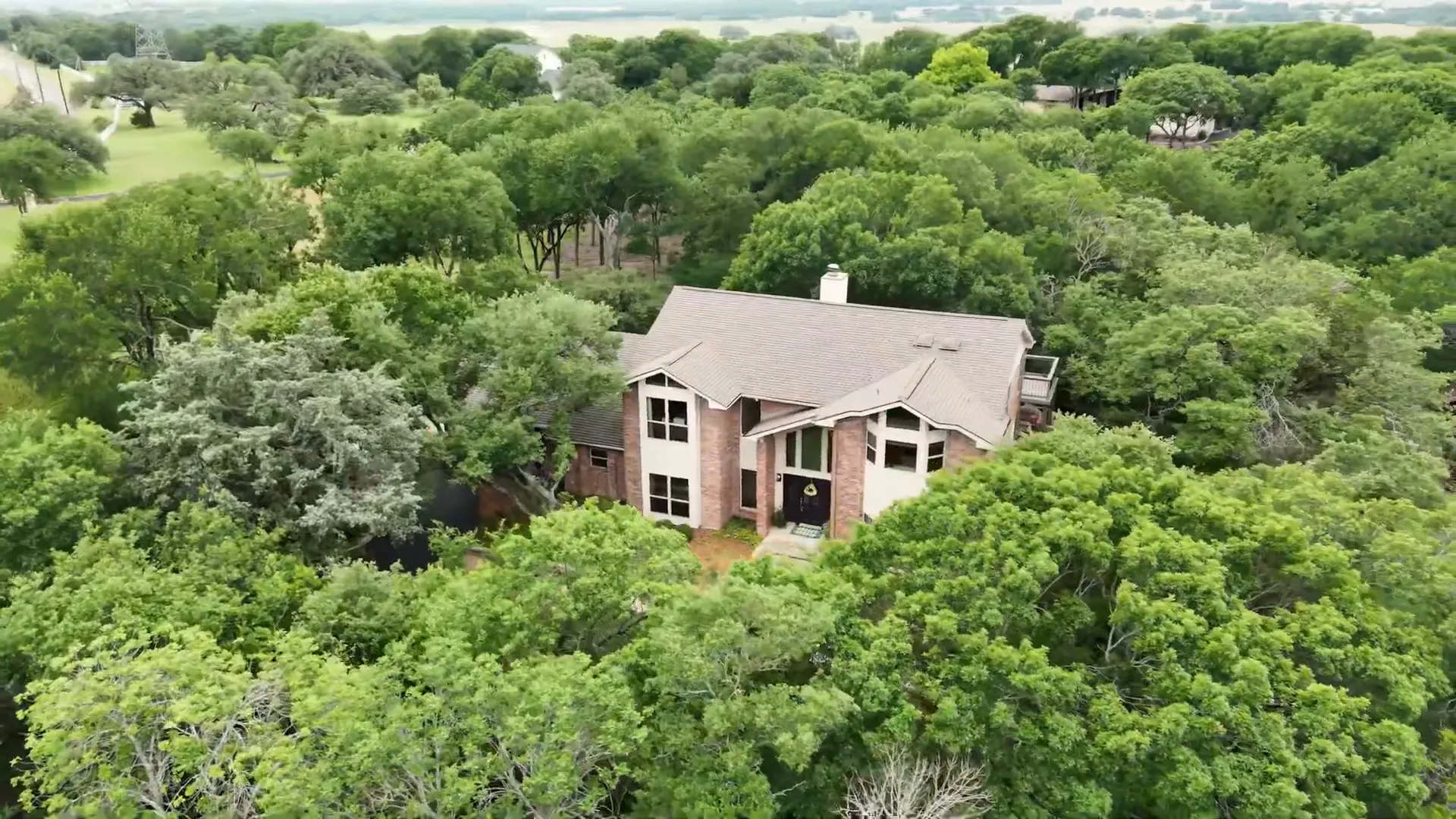 View of the wooded lot and seasonal creek