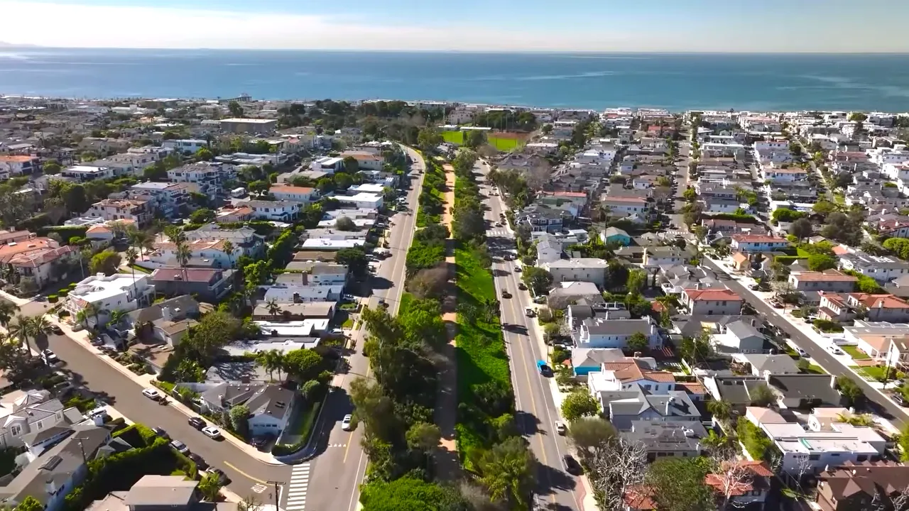 Aerial view of coastal neighborhood with median sale price graphic showing 3.3 million dollars and 10 percent change