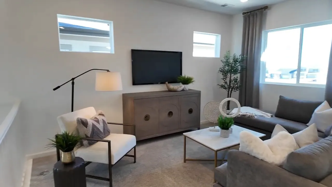 Second-floor loft seating area with large windows in Tri Pointe Aurora Highlands