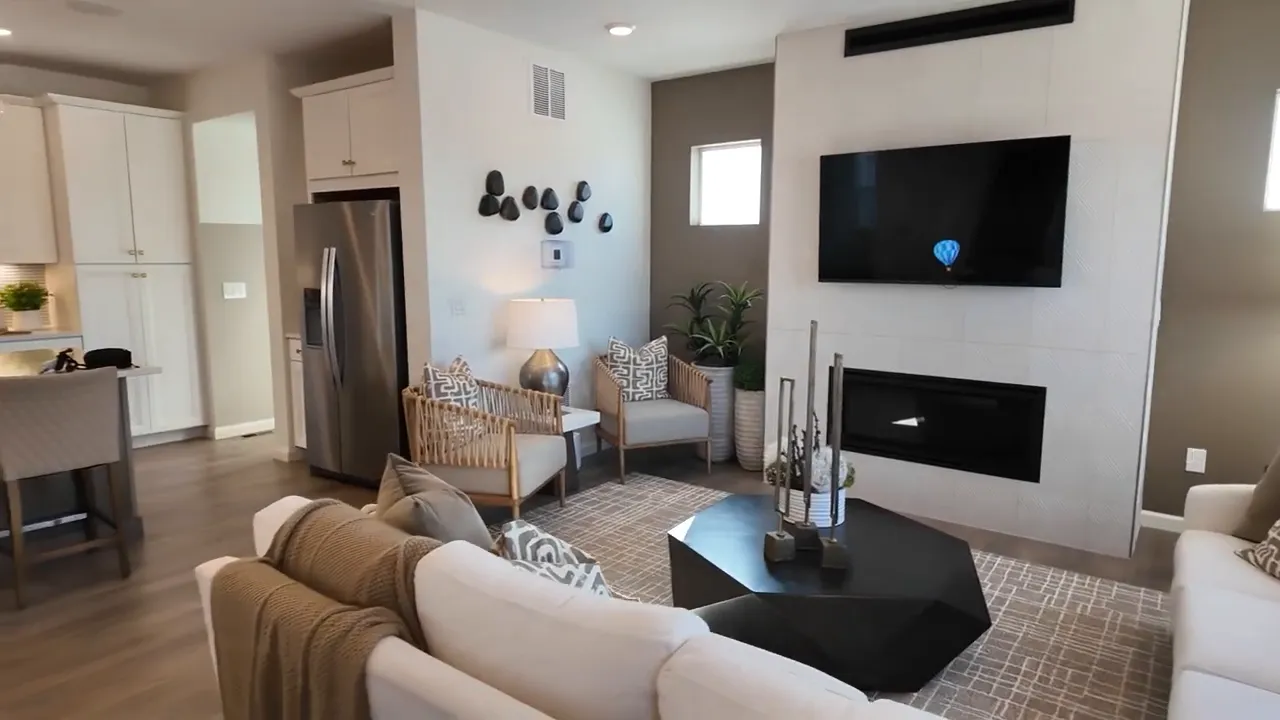 Crescendo plan 3203 living room view toward kitchen and dining area at Aurora Highlands
