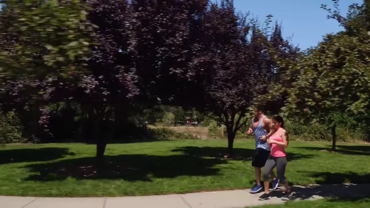 Joggers on a sidewalk in a green park with text reading over 41 parks