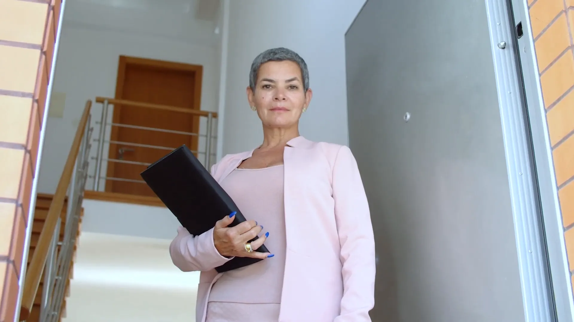 Real estate agent holding a folder with text asking do i need a realtor