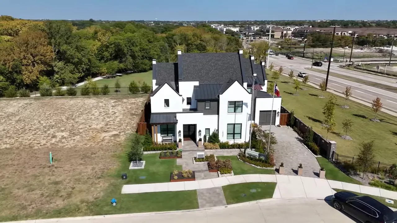 curved staircase and rotunda entry with hanging lights and hallway leading through the home