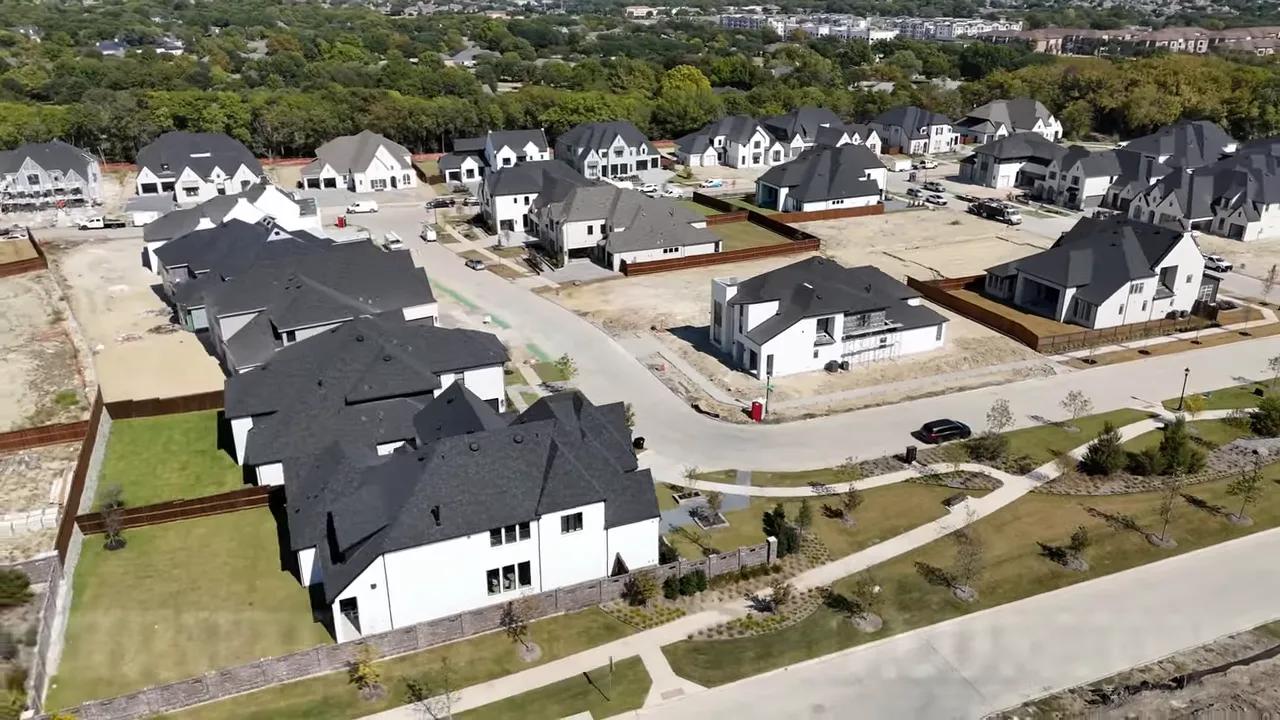 Covered outdoor living area with lounge seating, dining table, twin ceiling fans and a view to the backyard.