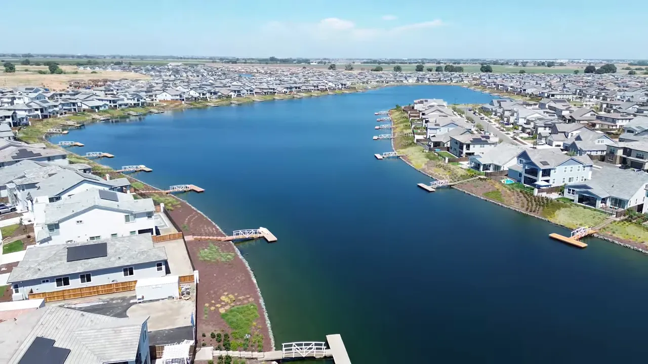 client on a couch discussing build quality with a kitchen island visible behind her