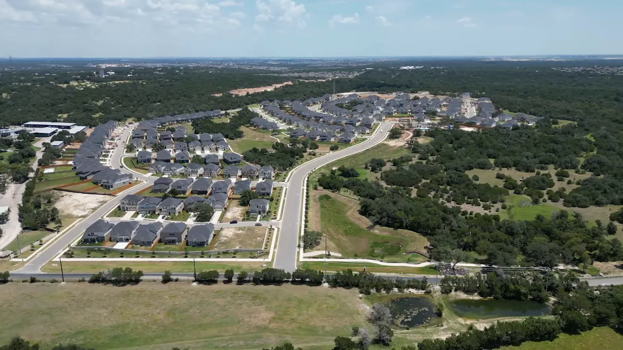 Spacious suburban backyard and two-story house demonstrating the extra yard space outside central Austin