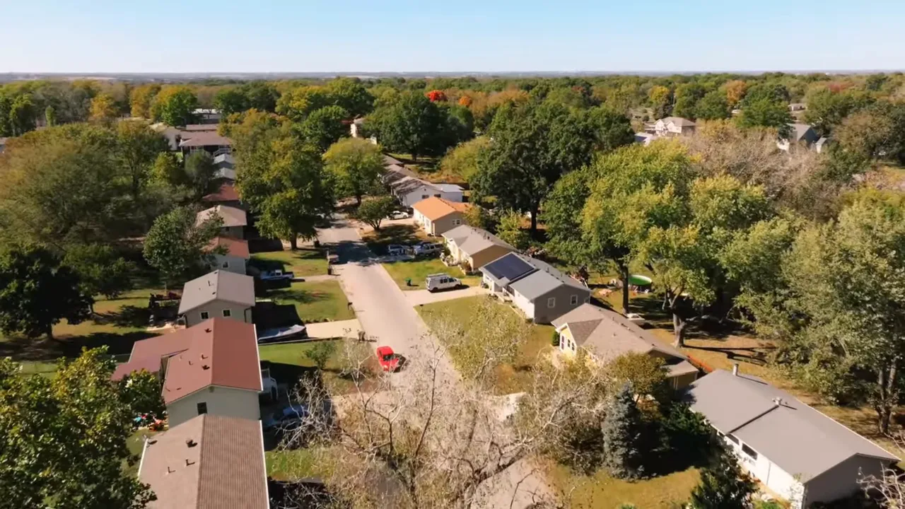 Front yard view of a home in Valley View, Warrensburg, Missouri with parked vehicles and large trees