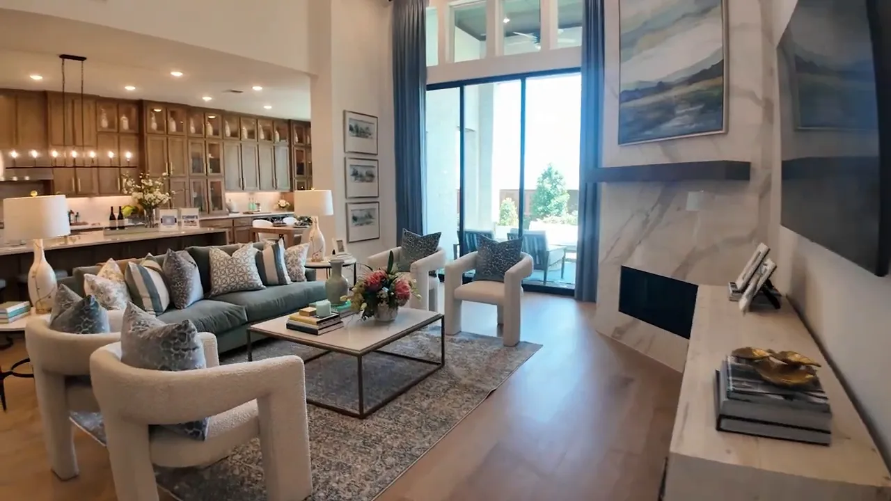 Open family room with sofa coffee table fireplace and kitchen beyond