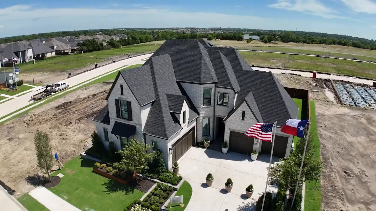 Front driveway with multiple garage doors and large planters