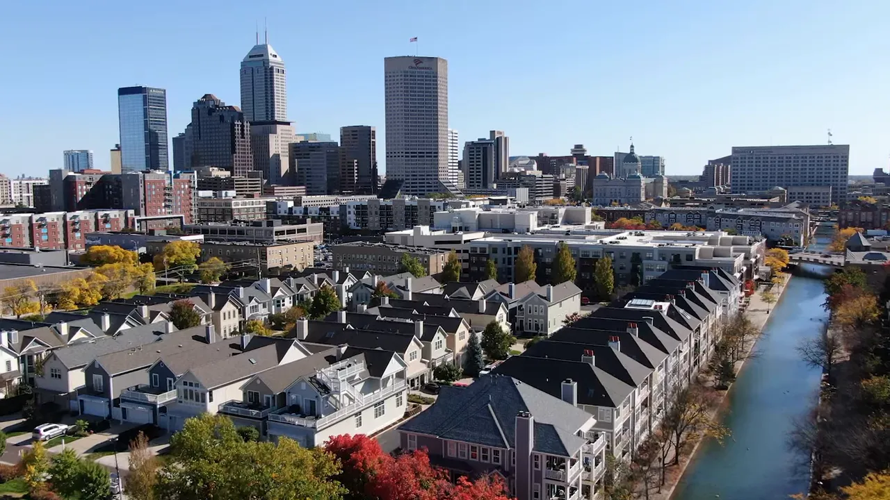 Aerial view of Carmel High School campus surrounded by trees, parking lots, and playing fields