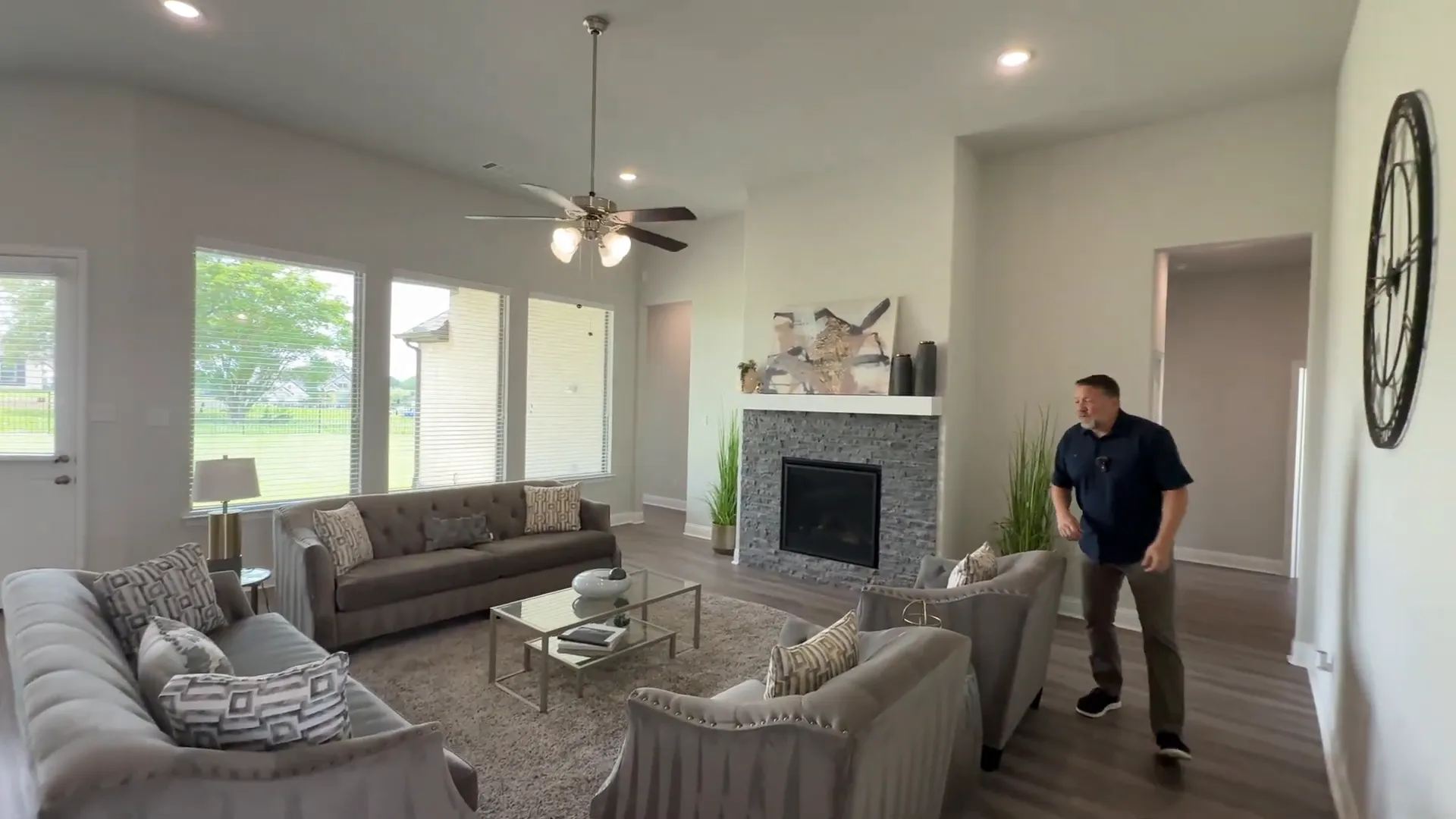 Living room area with large fireplace and open access to kitchen