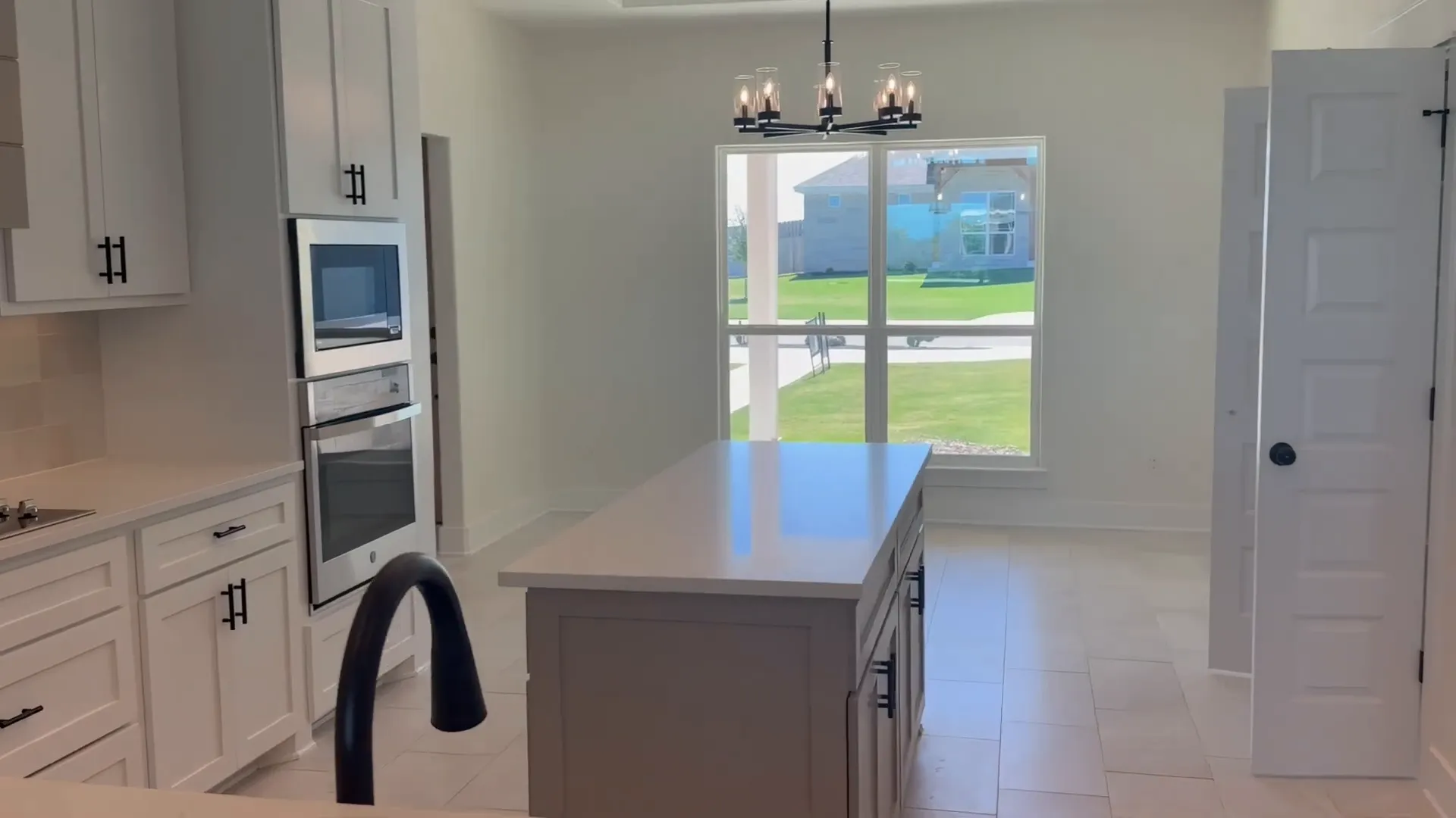 Chef's kitchen island with custom cabinetry and pendant lighting