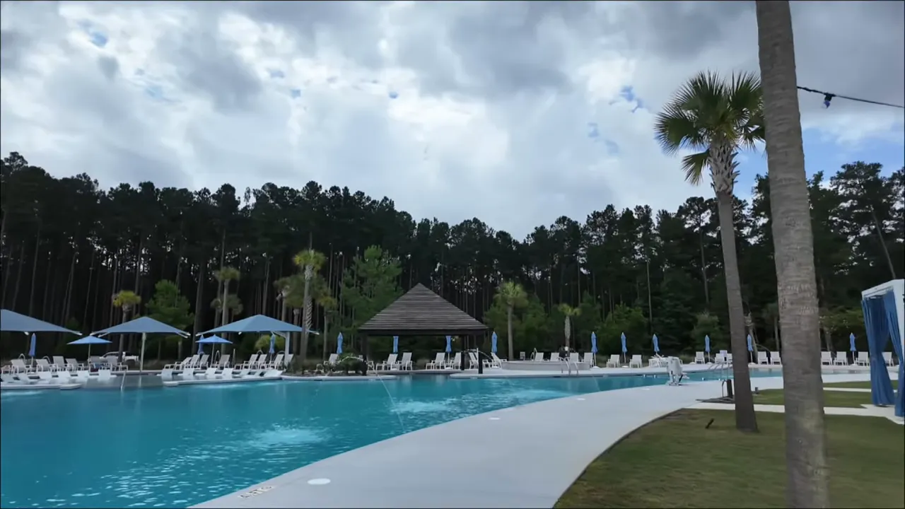 Exterior front view of a Del Webb Nexton Palmary model home with covered porch and garage.