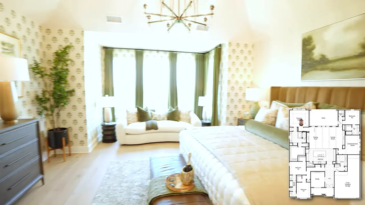 Large primary bedroom with king bed sitting area and patterned wallpaper